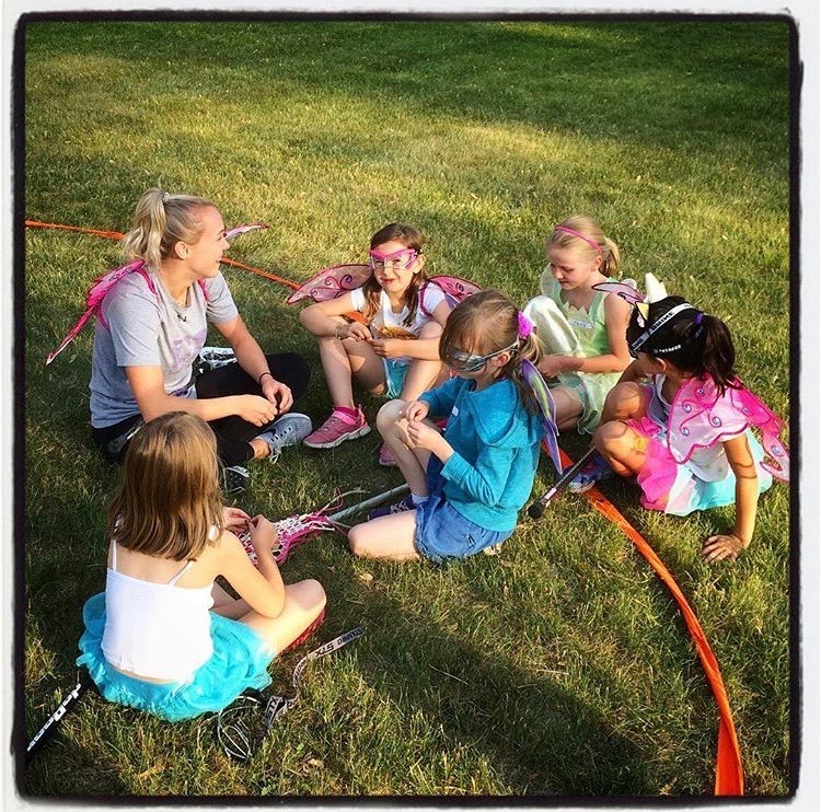 Photo of myself coaching lacrosse with Primary-Junior aged athletes